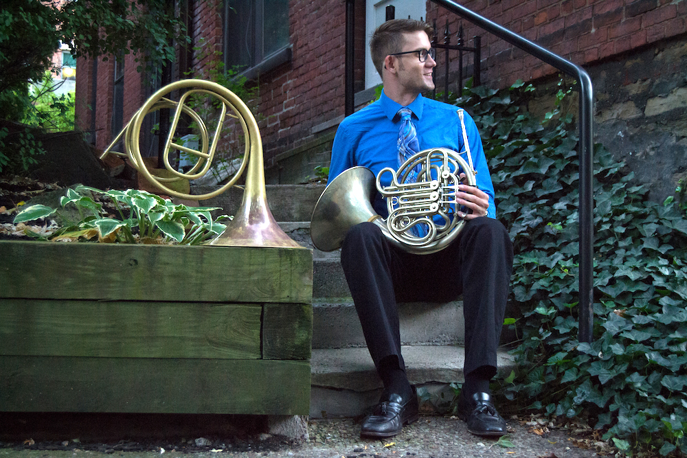 robert levine sitting with a modern french horn